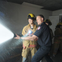 Fire Training Students
  -photo Mike Wakefield  May10/17
 
 Fire Fighter training for High school students ,part of Career Day 2017 through the NVSD44 . Students from across the District were brought to the NV Fire Training centre and run through some fire fighter training.Capt Gunther Kramer leads a group through fire suppression training.-News